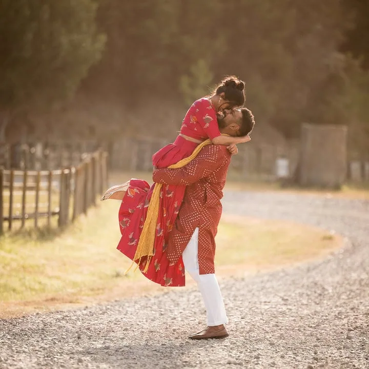 Bride and groom embracing at traditional indian wedding at Kiwiesque