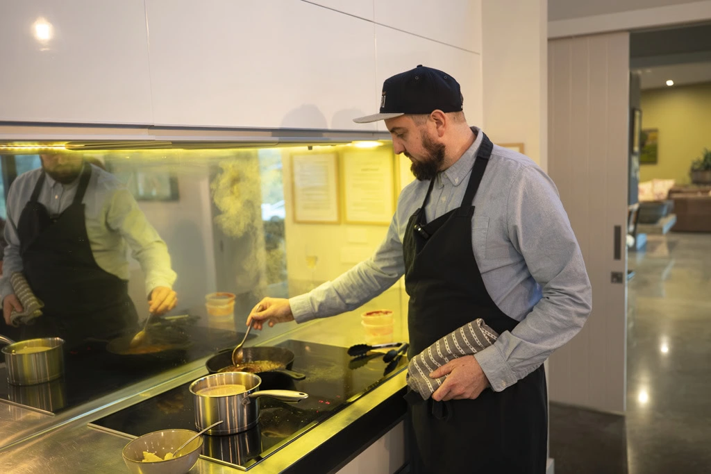 Chef Simon Lillico cooking in the kitchen at a Kiwiesque Winter Food and Wine Experience